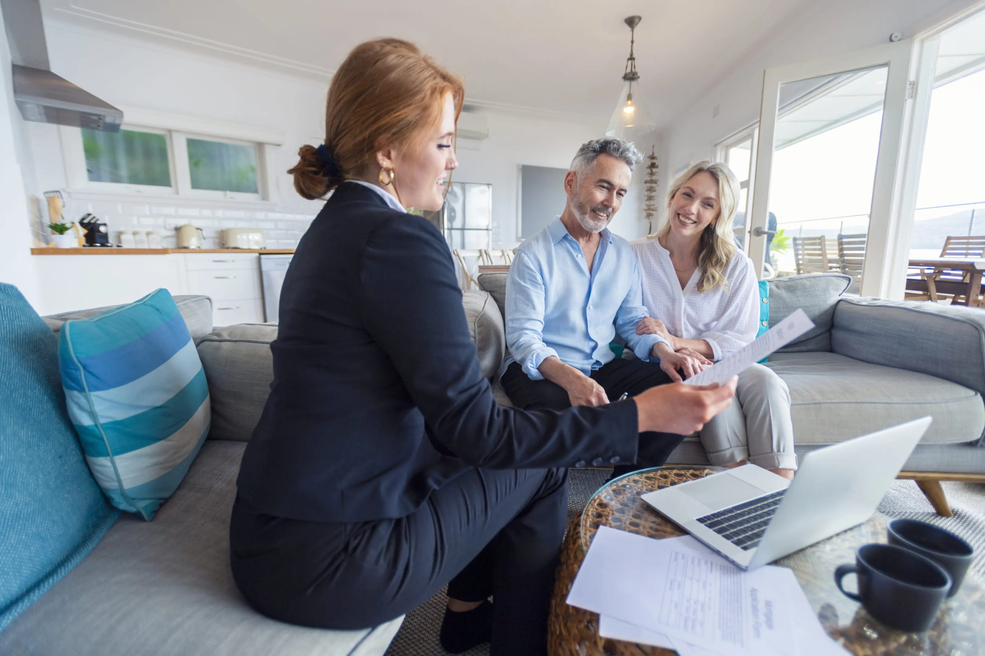 Agent meeting with couple in living room.